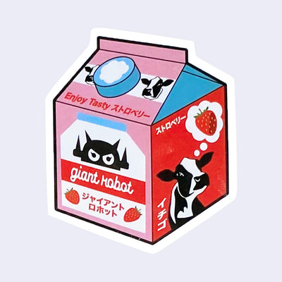 Die cut sticker of a small carton of strawberry milk, with a graphic of a cow thinking of a strawberry on the side. On the front, reads "giant robot" below its robot logo and strawberries.