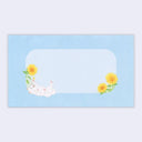 Blue envelope with illustrations of a white dog playing with sunflowers.