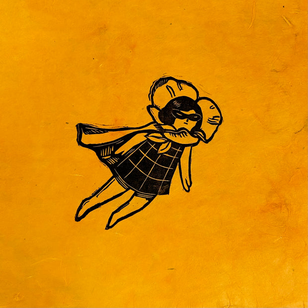Black ink relief print on bright orange fibrous paper of a girl in a plaid dress and a superhero mask and cape, flying through the air. Around her neck, like a collar, is a poppy flower.