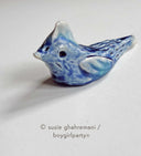 Ceramic sculpture of a blue bird.