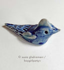 Ceramic sculpture of a blue bird.