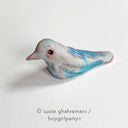Ceramic sculpture of a blue bird.