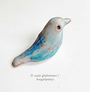 Ceramic sculpture of a blue bird.