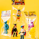 Set of colorful action figures in packaging on a yellow background