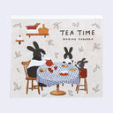 Memo pad with an illustration of a family of rabbits sitting at a table and having tea.
