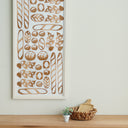 Decorative wall art with bread illustrations on a light background