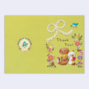 Greeting card with teddy bear, cat, and flowers on a green background