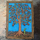 Illustration with unique line art patterning of a tree with bare branches, intertwined with one another with orange flowers and green leaves growing off sparingly. At the base of the trunk is a small green rabbit, dressed and standing on 2 legs like a person.