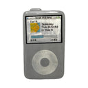 A gray plastic ceramic item shaped like an iPod, featuring a printed screen with 'Now Playing' text and album artwork, and a circular click wheel on the front, isolated on a white background.