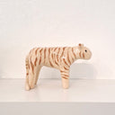 Ceramic sculpture of a light tan colored tiger with brown striping and an oval shaped face.