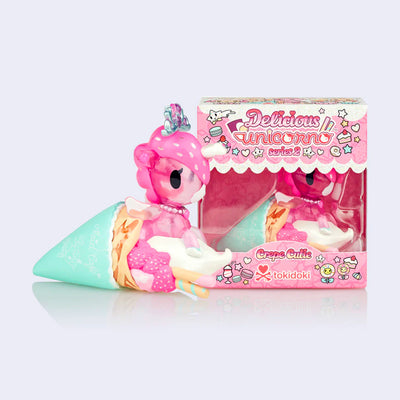 Pink semi transparent unicorn figure with pink strawberry mane wrapped inside of a strawberry crepe.