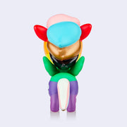 A vinyl unicorn colored like various pride flags, rainbow body with baby pink, blue, bronze and black hair.