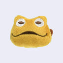 Plush toad's head attached to a brooch safety pink backing.