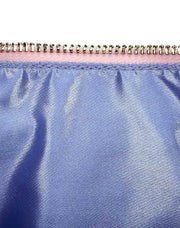 Inner lining of bag, featuring lavender satin fabric and a strip of pink fabric lining the gold tone zipper.