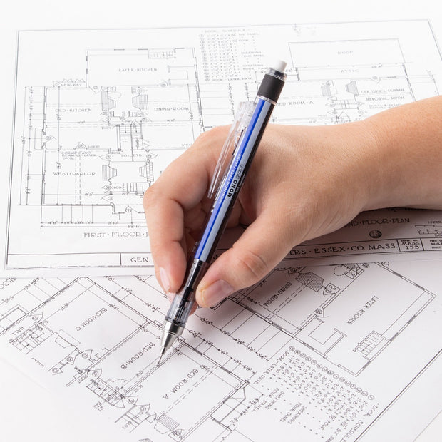 Someone holding a mechanical pencil while drawing architecture plans.