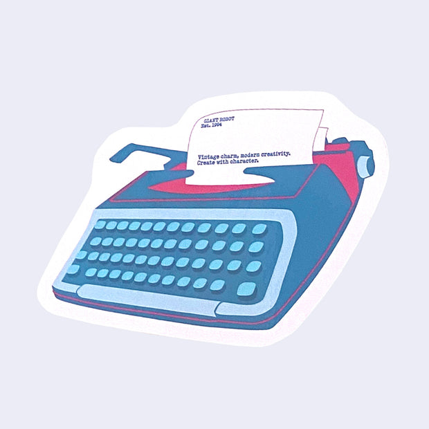 Die cut sticker of a blue typewriter with pink color accents, with a sheet of paper that reads "Vintage charm, modern creativity. Create with character."