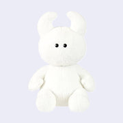 White plush toy with black eyes and soft curved horns.