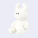 White plush toy with black eyes and soft curved horns.