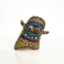 Colorful clay sculpture with intricate patterns on a white background