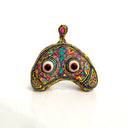 Colorful decorative object with eye design on a white background