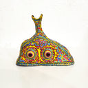 Colorful decorative object resembling a fish shape on a white background
