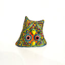 Colorful owl-shaped clay sculpture with geometric patterns on a white background