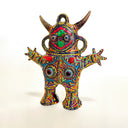 Colorful abstract figurine with intricate patterns on a white background