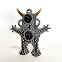 Decorative figurine with intricate patterns and brown horns on a white background