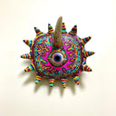 Decorative wall art with colorful patterns and a horn on a light beige background