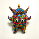 Colorful decorative figurine with intricate patterns on a white background
