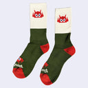 Socks with olive green, cream and vermillion coloring.