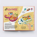 Open book with colorful illustrations of a children's lunch menu and text on a white background