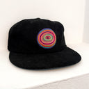 Black cap with a colorful spiral design on a white background