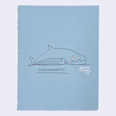 Illustration on blue paper of a whale laying with a worried expression.
