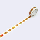 Roll of washi tape with a design of taiyaki, a Japanese fish shaped pastry.