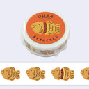 Roll of washi tape with a design of taiyaki, a Japanese fish shaped pastry.