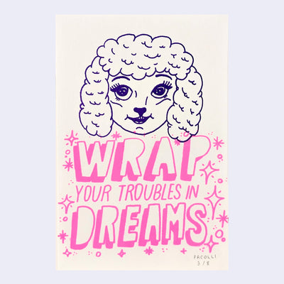 Print of a purple lamb head, cartoonish with mascara. Below, reads "Wrap your troubles in dreams."