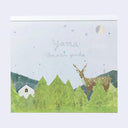A square memo pad featuring a whimsical forest illustration with pine trees, a deer, a small white house, and the handwritten text 'Yama / omori yuko' on a pale background.
