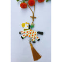 Tassel hanging of a flat clay sculpture of a white spotted horse with beads on a brown tassel.