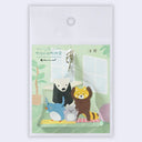 Keychain with cartoon animals practicing yoga on 2 yoga mats.