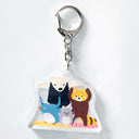 Keychain with cartoon animals practicing yoga on 2 yoga mats.