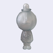 Translucent gray sculpture of a cratered moon with a simplistic, closed eye smiling face. It wears a bowler hat and a suit, arms at its side, with painted silver dots on the hat and suit. Sculpture is reminiscent of Magritte.
