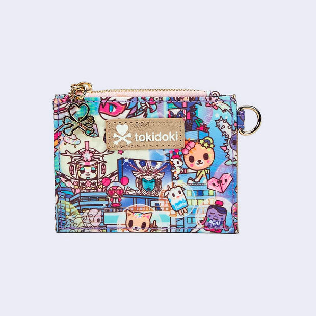 Small square-shaped wallet, with gold zip top and a mint blue name plate that reads "tokidoki". Wallet is covered completely in a busy colorful pattern featuring tokidoki characters with with galactic and sci fi imagery.