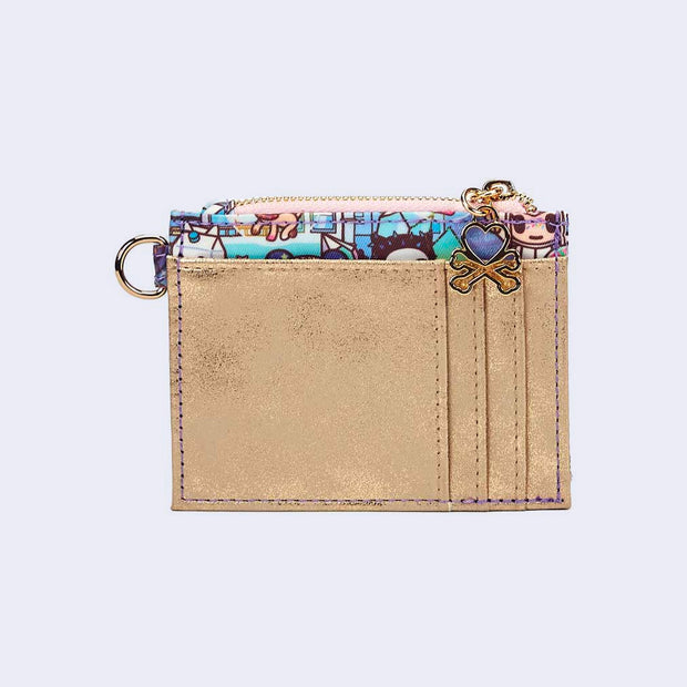 Back of small, compact square shaped wallet. Exterior is metallic champagne colored pleather with a 3 card slot