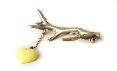 Princess Tina - silver Antler Brooch with a yellow heart hanging from a chain.