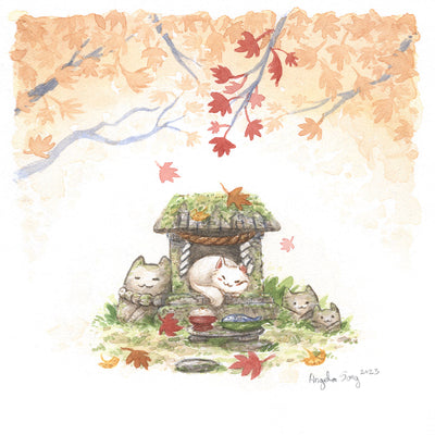 Watercolor painting of an autumn scene with orange and red leafed trees at the top of the piece, over a small stone shrine that has been overgrown with moss and greenery. Stone cat heads are around it and a white cat sleeps happily in the center, in front of a plate of fish and rice offering.