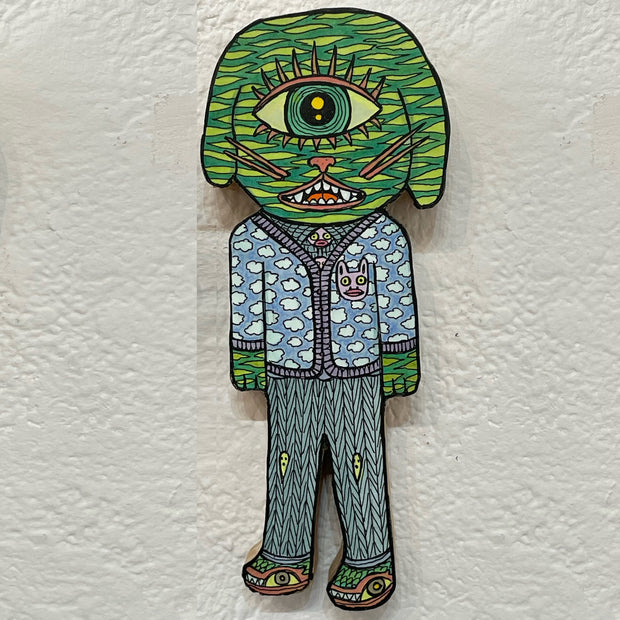 Illustrated wood cut of a dog-like monster with a singly eye, wearing a cardigan with a cloud pattern and pants with little ghosts as knee patches.