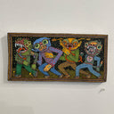 Illustration on wood of 2 colorful goblins with patterned outfits and two humans inside of goblin costumes walking with arms linked all together. 