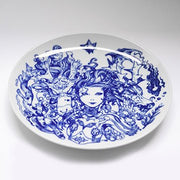 White ceramic plate features a woman with long, wavy hair and mechanical body, one hand lightly touching a dragon head, with another dragon is on her opposite side.