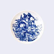 Small white ceramic plate with deep blue intricate line art. Plate features a small girl surrounded by a cat shooting white static out of its eyes and other animals and animal masks.